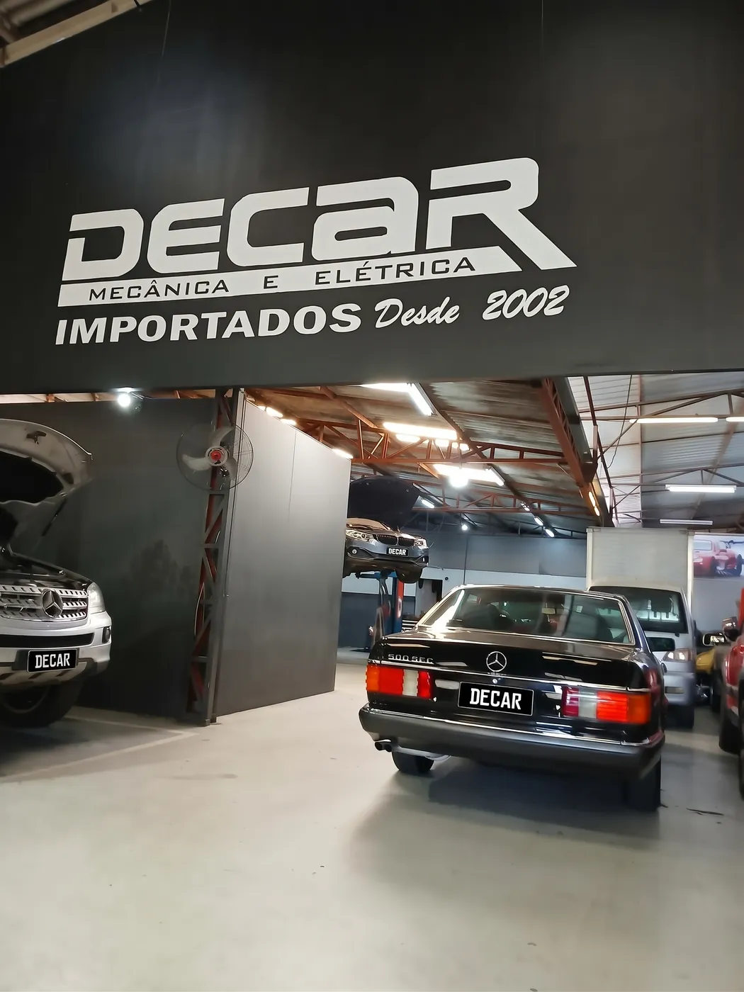 Mercedes 500 SEC na oficina da Decar, sob a placa da empresa